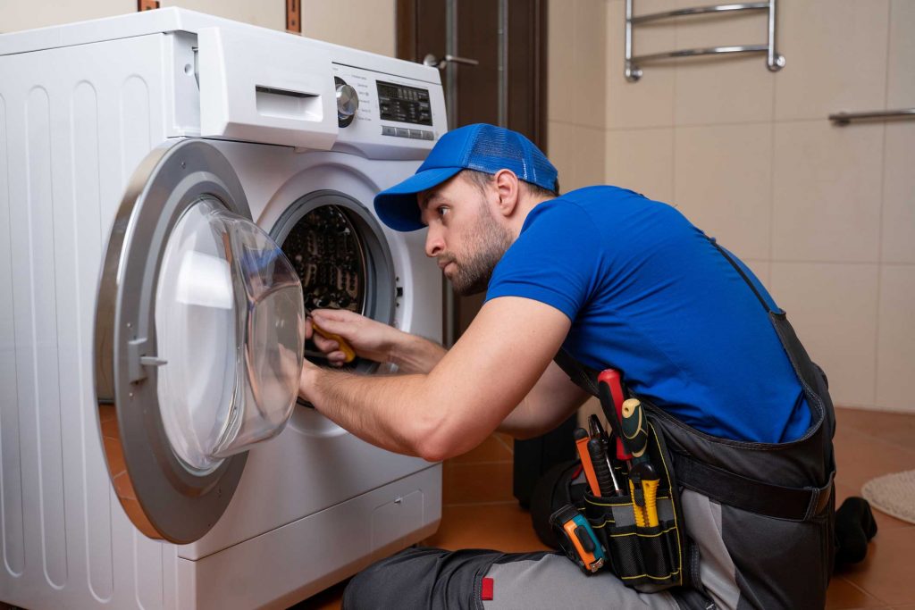 a technician repairing a washer and dryer repair gastonia